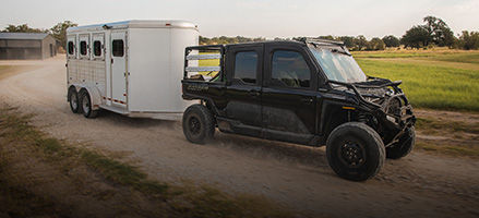 A 2025 extreme duty UTV hauling heavy cargo on a trailer. 
