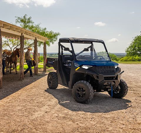 Una persona quitando nieve con un UTV Polaris RANGER 1000 CAB de 2027.