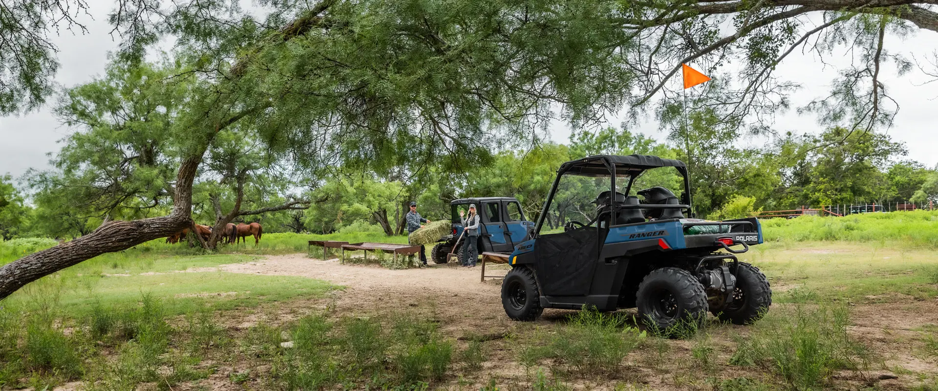 2 kids driving around the farm in their 2027 Polaris RANGER 150 EFI youth UTV.