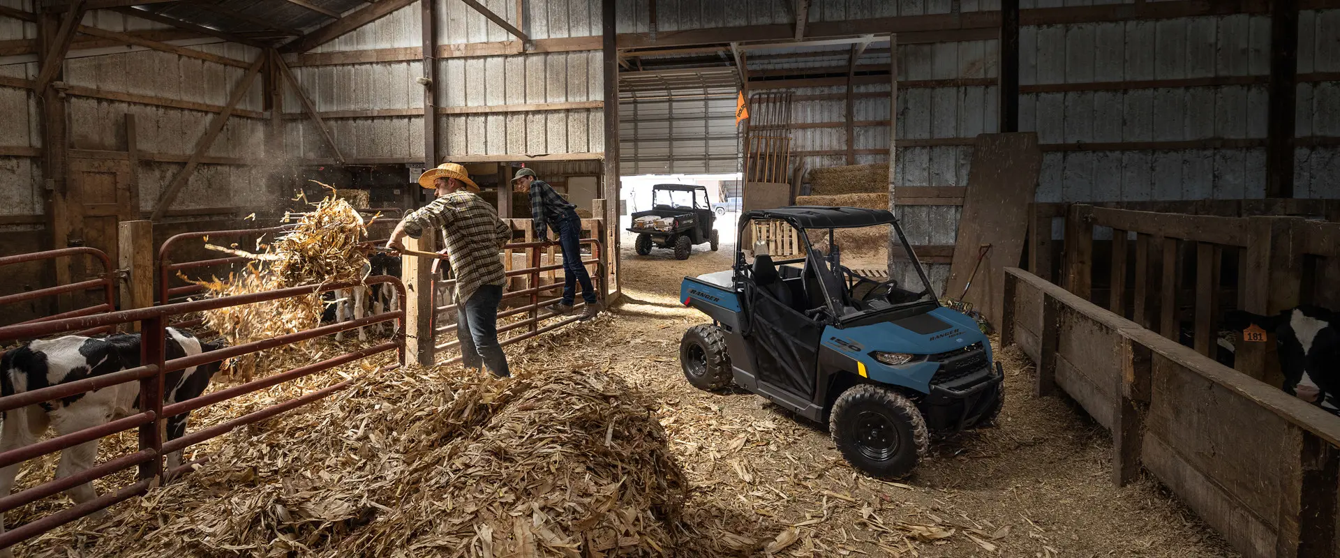 A kid in the barn with his 2027 Polaris RANGER 150 EFI youth UTV.