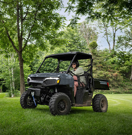 A man in a 2027 Polaris RANGER 500 UTV driving on his property.