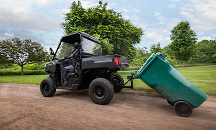 A 2027 Polaris RANGER 500 UTV pulling a trashcan home.