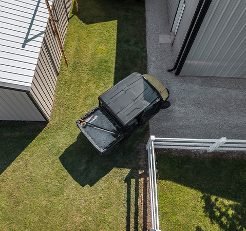 A 2027 Polaris RANGER 600 UTV taking a tight turn on a farm.