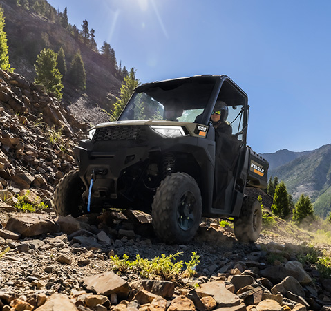 2 riders in a 2027 Polaris RANGER 600 UTV showcasing the 11-inch ground clearance.
