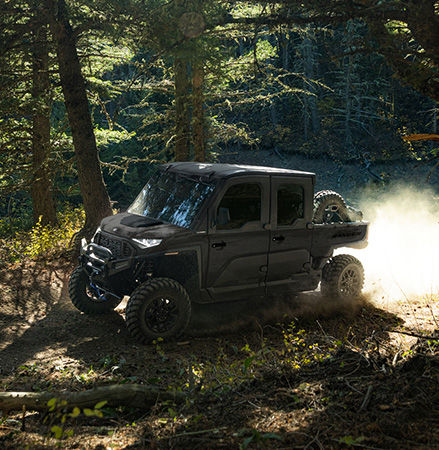 A 2027 Polaris RANGER CREW XD 1500 NorthStar Extreme Duty UTV using hill assist while climbing a hill.