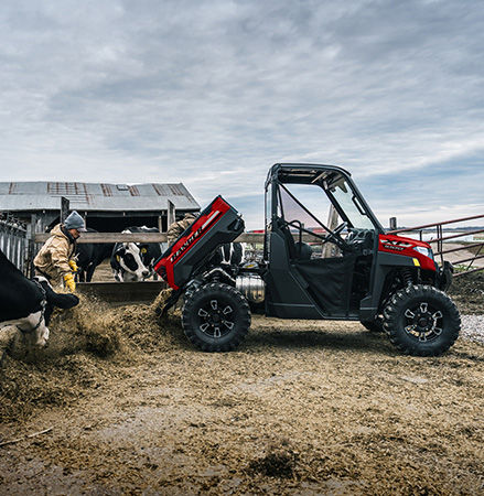 Gas-assist dump box on a 2027 Polaris RANGER XP 1000 UTV being used by a farmer to unload silage.