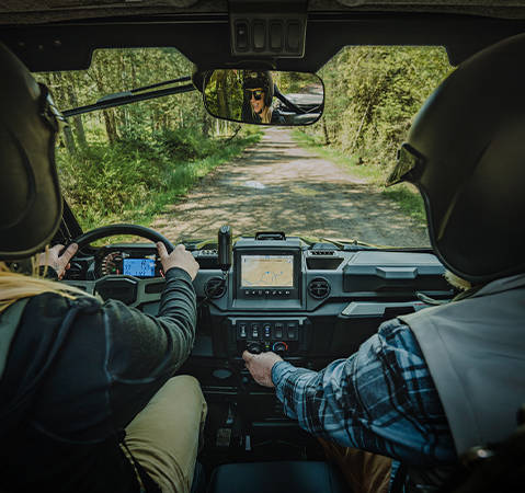 A person using the HVAC controls while in the cab of a 2027 Polaris RANGER XP 1000 NorthStar Trail Boss Edition UTV.