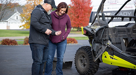People checking the Polaris Ride Ready Services of an off-road vehicle