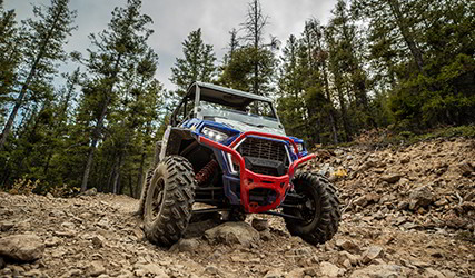 Front 3Q view of a RZR on rocks