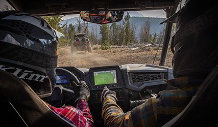 Two RZR riders using the Ride-Command feature