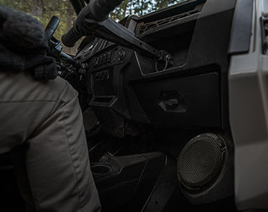 Polaris RZR Trail racing on a trail road in the sunset