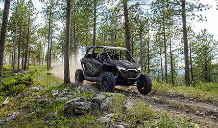 RZR Pro XP 4 que acelera por un sendero en el bosque