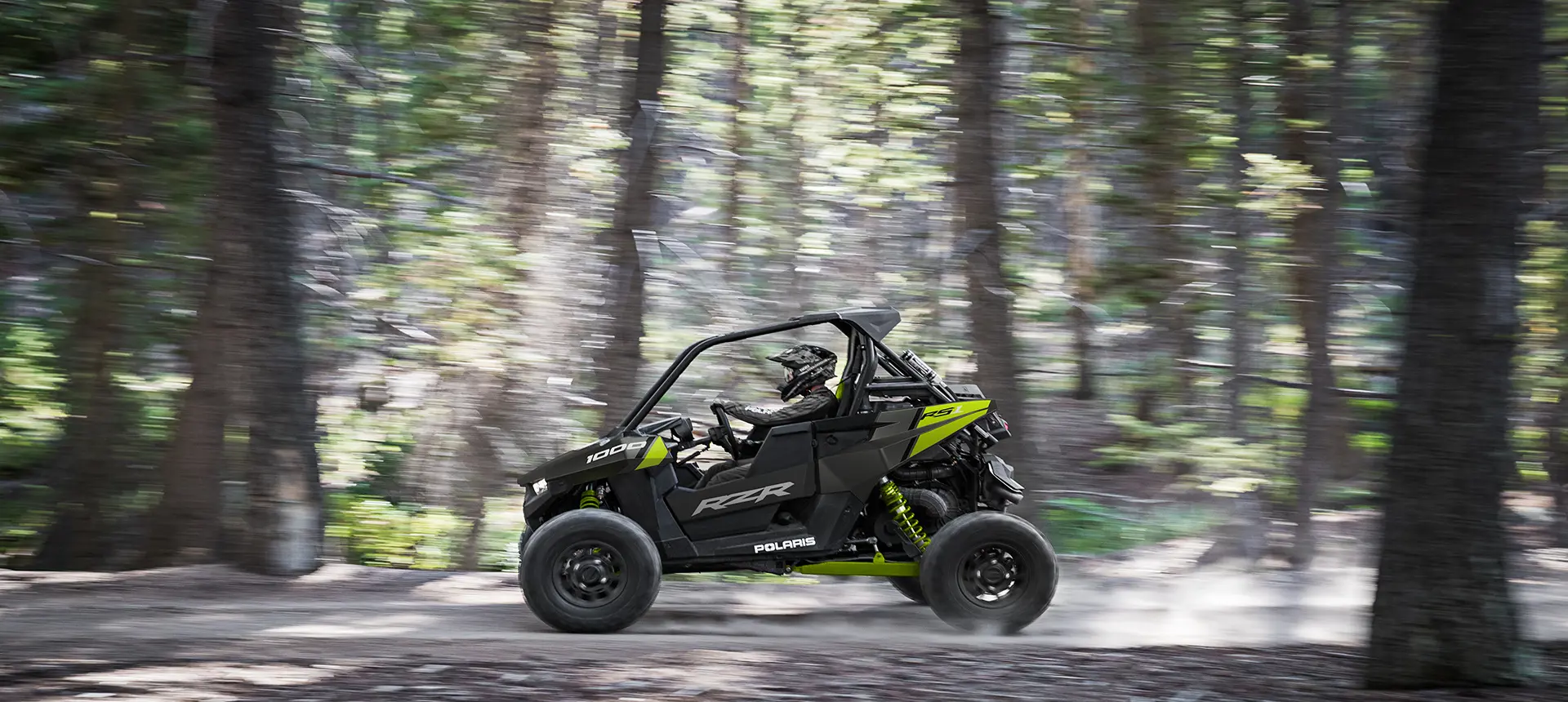 polaris RZR RS1 racing down a forest trail