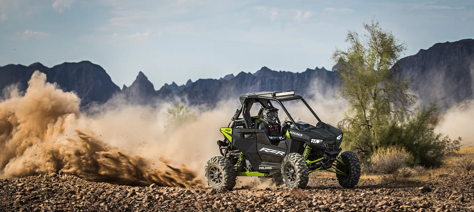 RZR RS1 racking down a trail on rocky terrain