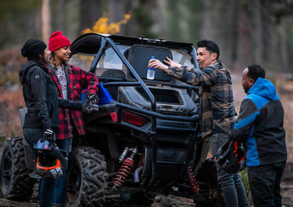 Man using the flexible storage options on his RZR Trail S