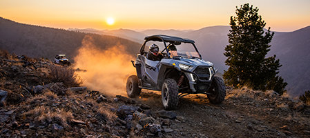 A RZR trail going through a rocky trail on the sunset