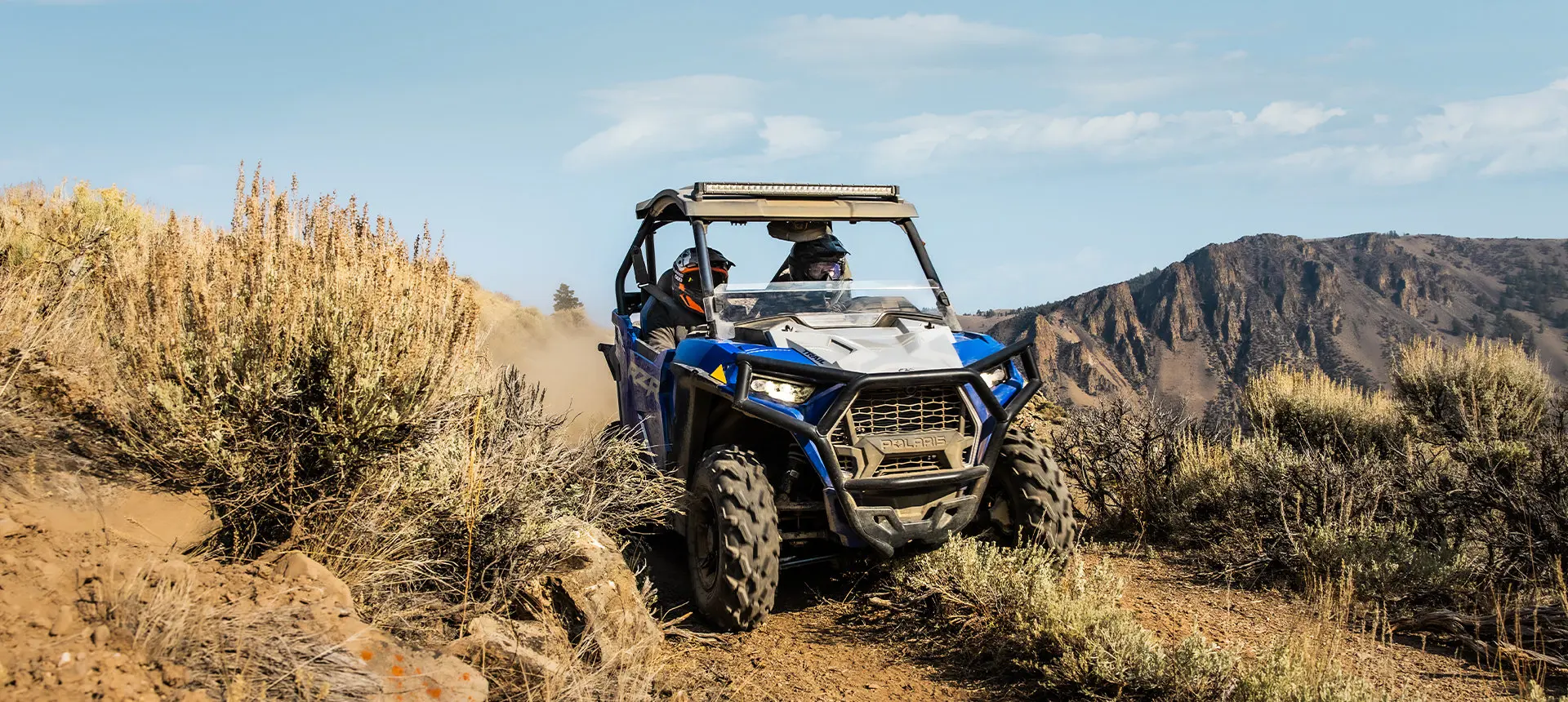 a rzr trail sport going through a mountain trail