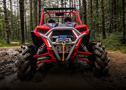 RZR XP 1000 High Lifter parked in muddy trail.