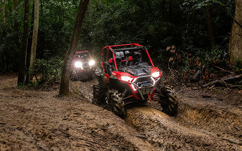 RZR XP 1000 High Lifter in a muddy trail through the forest