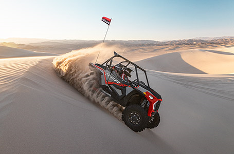 polaris rzr xp 1000 driving through the dunes