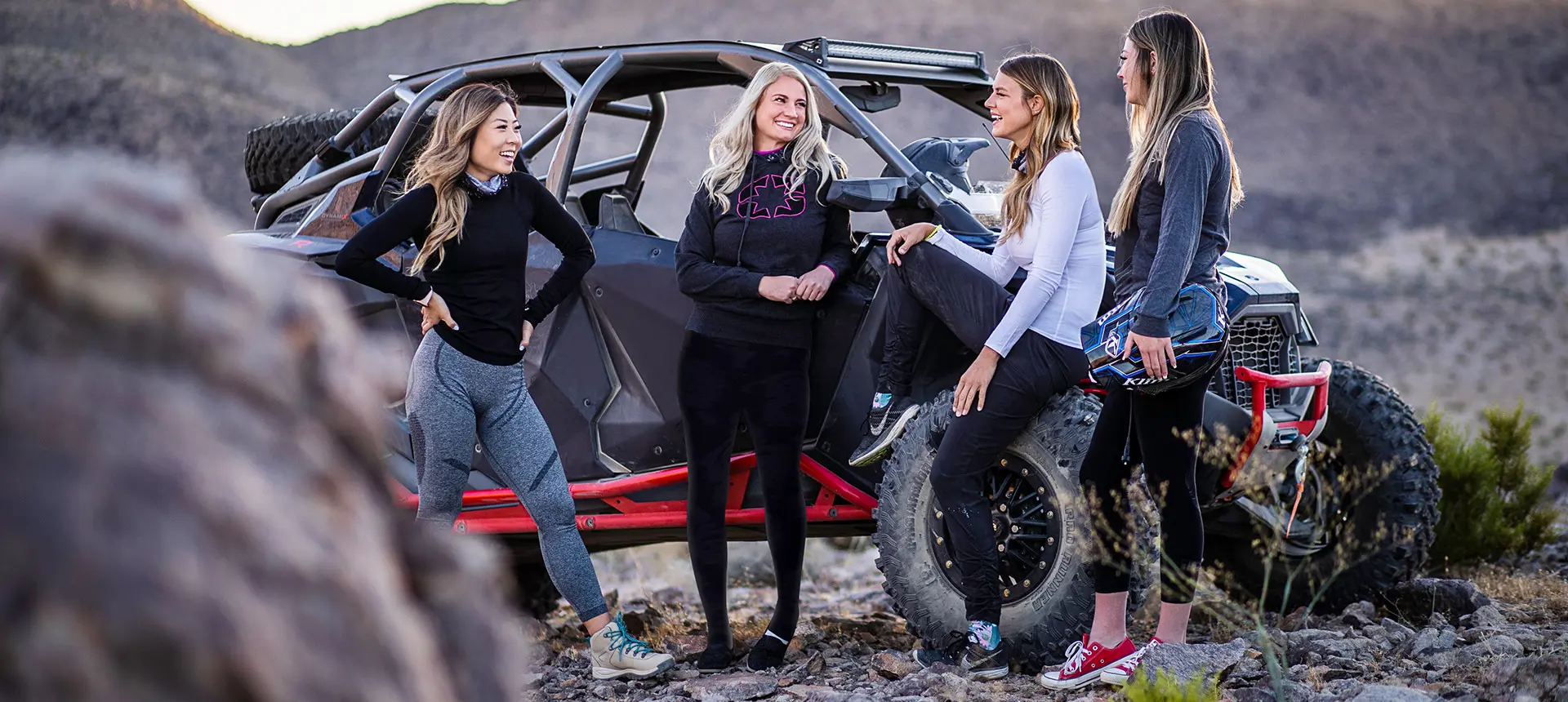 un grupo de mujeres relajándose después de un paseo en su polaris rzr pro r 4 side by side