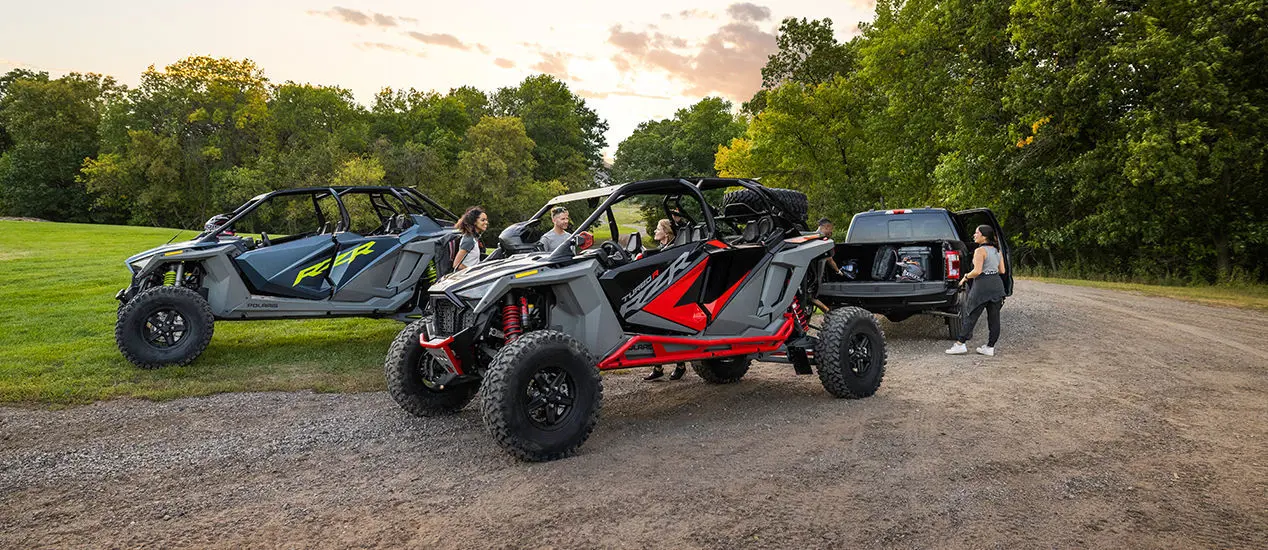 people preparing for a ride in their polaris rzr turbo r 4 side by sides