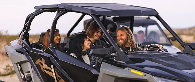 riders having a good time in a polaris rzr turbo r 4 side by side