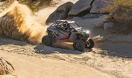polaris rzr turbo r kicking up dirt in the desert