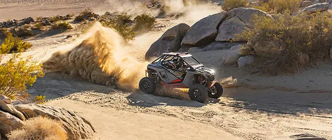 polaris rzr turbo r throwing dirt in the desert