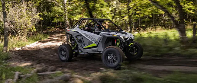 polaris rzr turbo r cruising on a forest trail