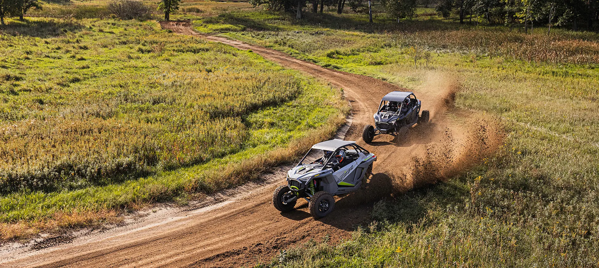 rzr turbo r and rzr pro r racing around a corner