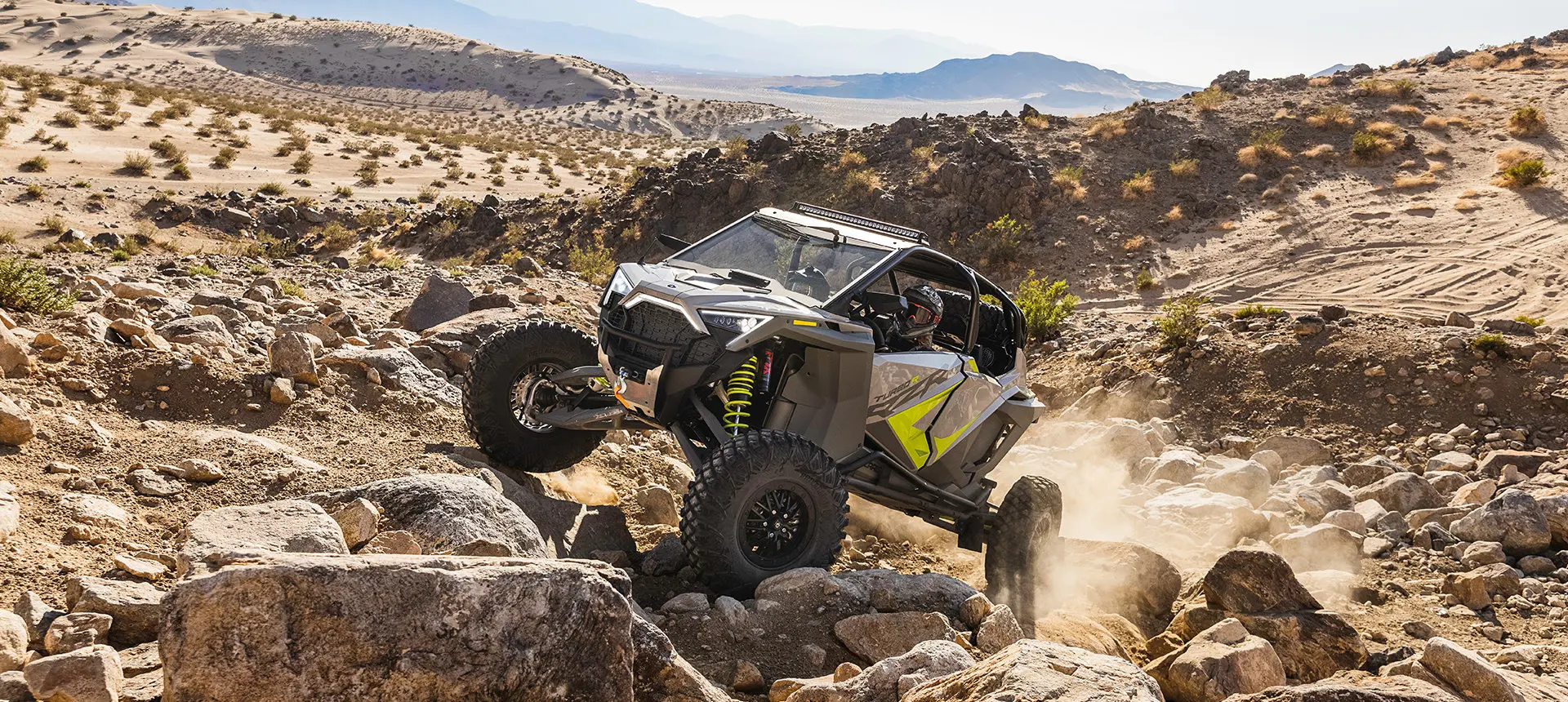 polaris rzr turbo r climbing over rocks