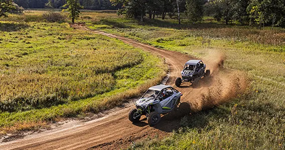 rzr turbo r and rzr pro r racing around a corner