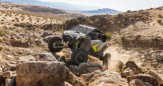 polaris rzr turbo r climbing over rocks