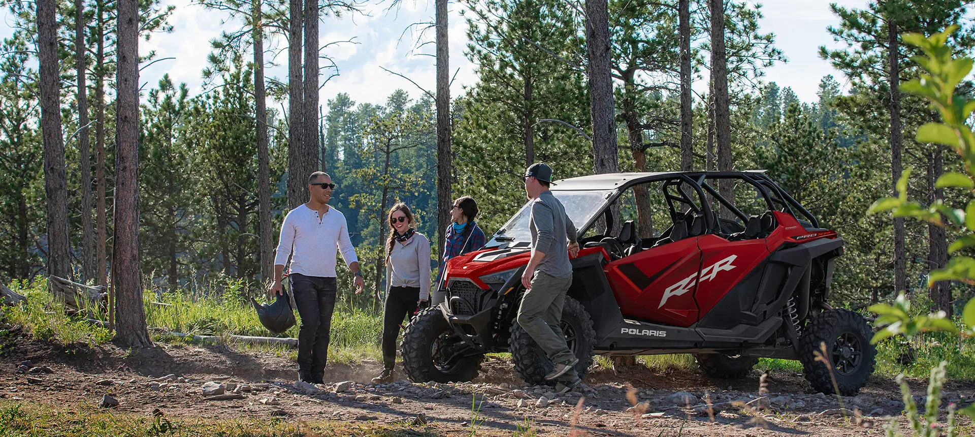 friends walking around their rzr pro xp 4 side by side