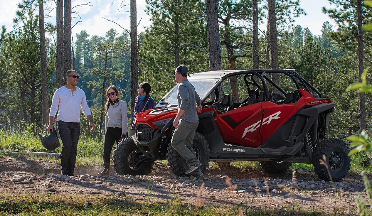friends walking around their rzr pro xp 4 side by side