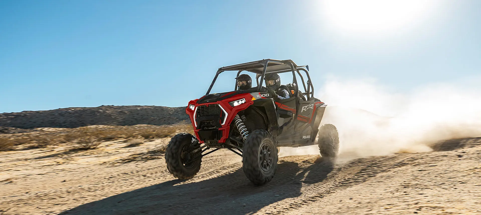 rzr xp 4 1000 with 4 passengers driving in the desert