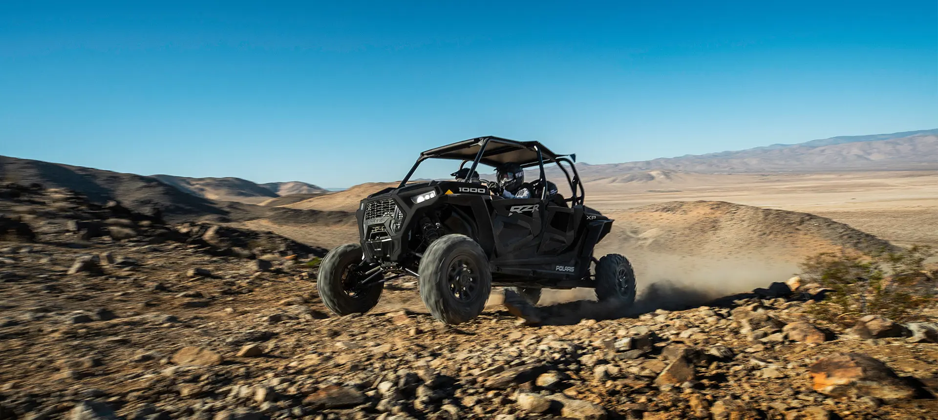 rzr xp 4 1000 driving over rocky terrain with ease