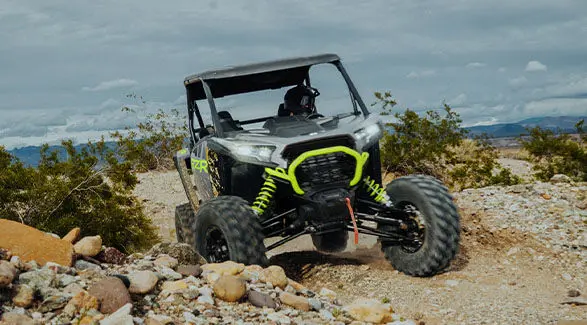 A storm gray 2025 RZR XP crawling with ease over rocky terrain.