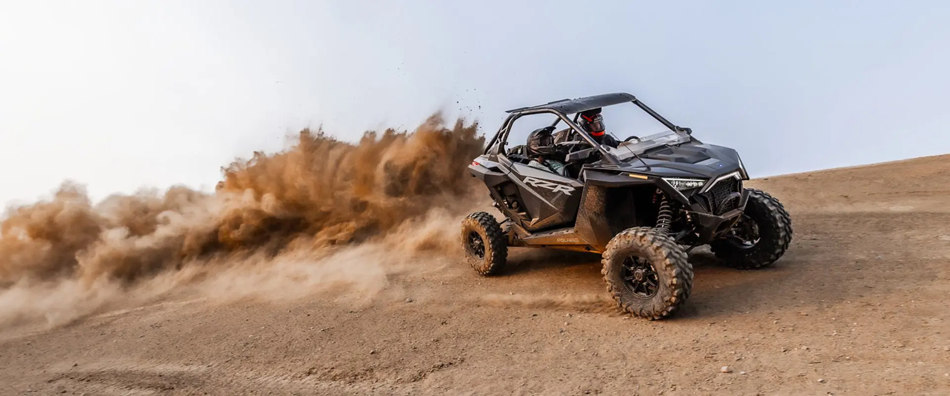 polaris rzr pro xp side by side throwing dirt in the desert