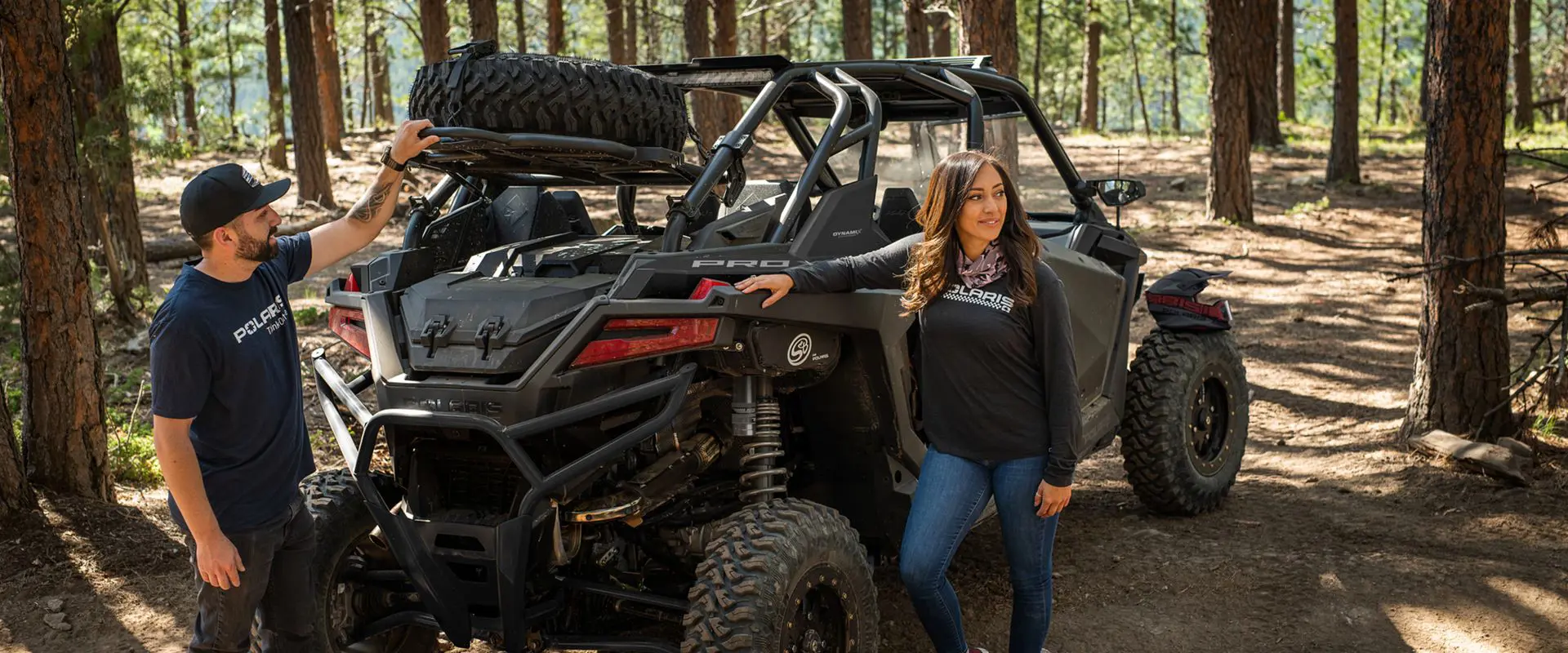 people hanging out near the rear end of a polaris rzr pro xp 4 side by side