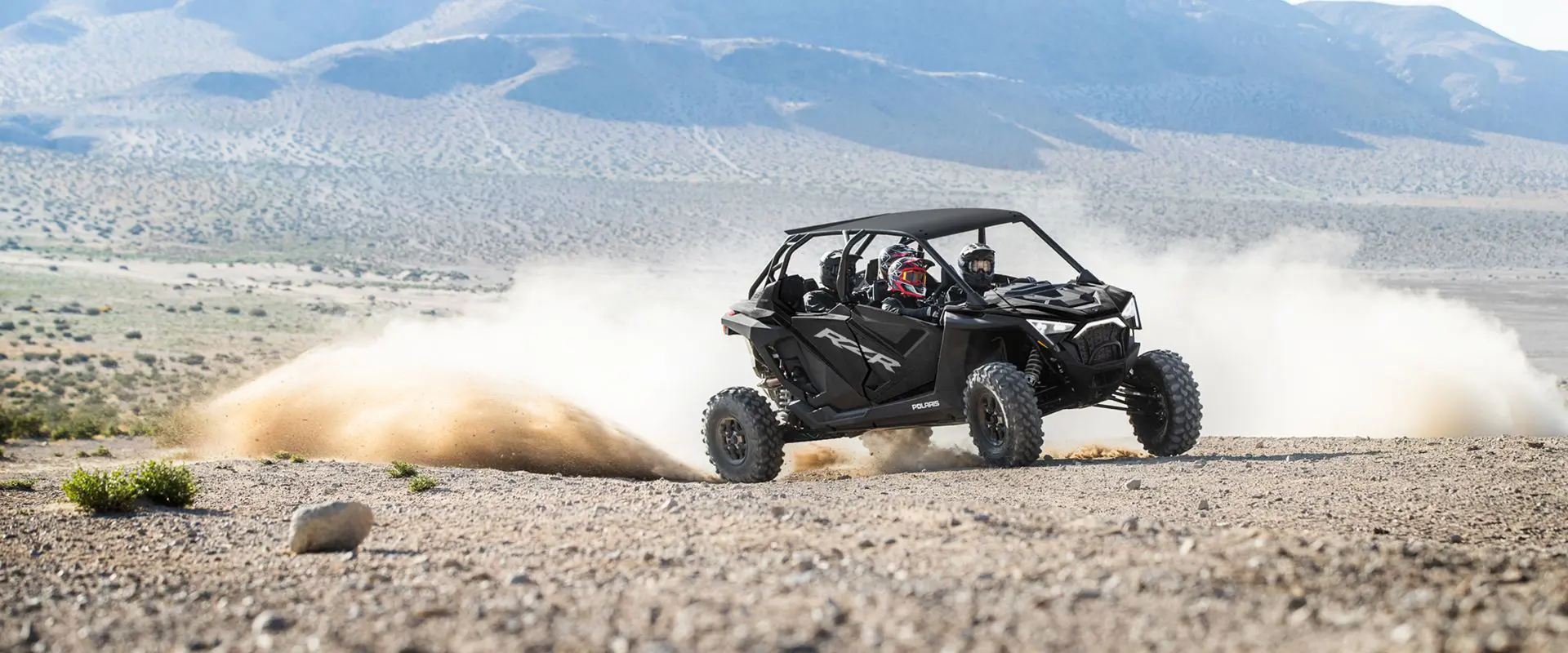 polaris rzr pro xp 4 side by side throwing sand in the desert