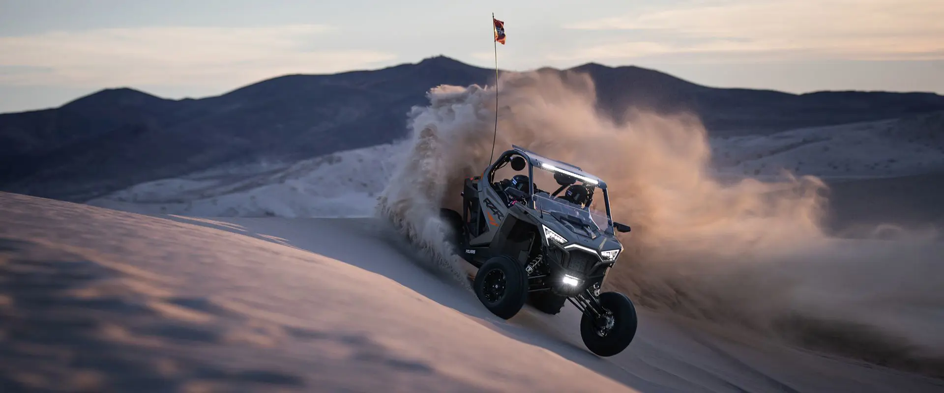polaris rzr pro xp side by side cornering in the dunes