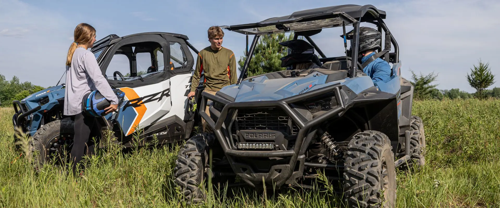 people getting ready to ride their polaris rzr trail s side by sides