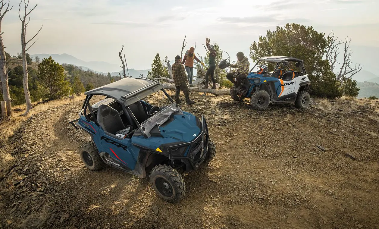 friends relaxing and having fun after a ride in their polaris rzr trail side by sides