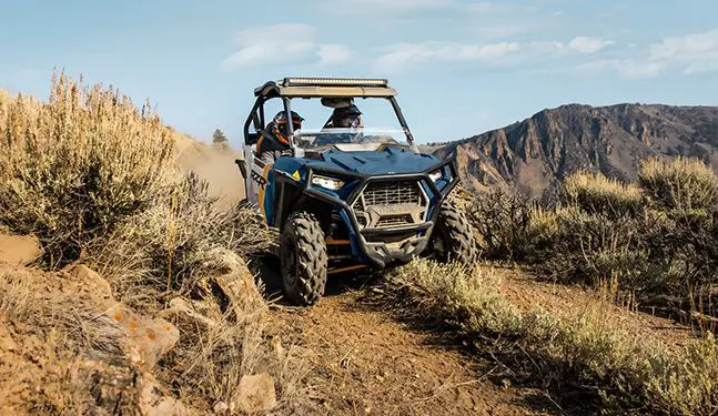 polaris rzr trail side by side driving on a trail