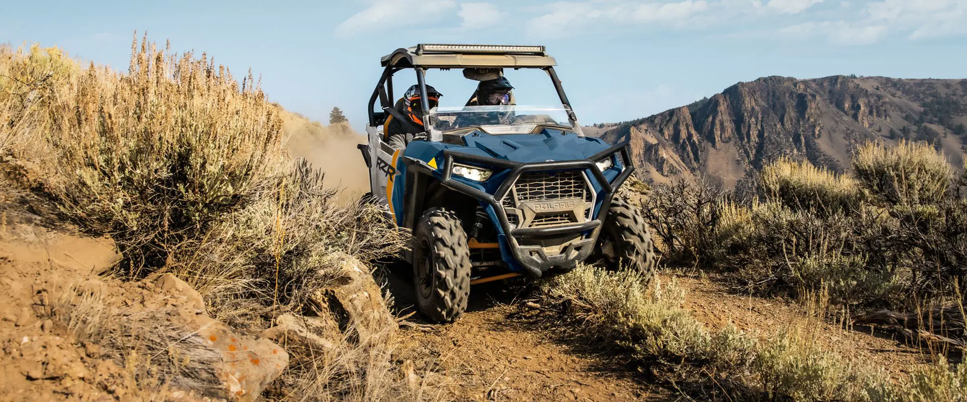 polaris rzr trail side by side driving on a trail