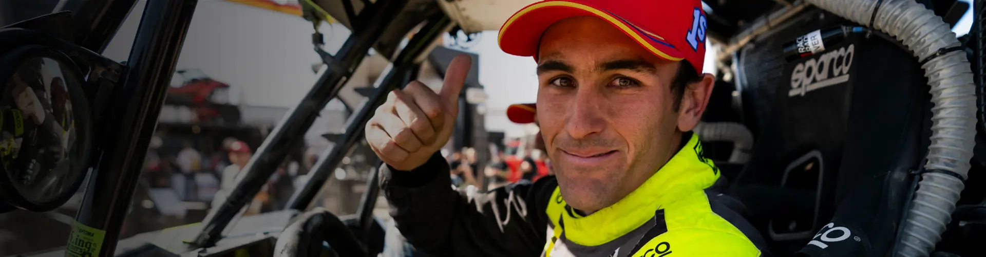 Brock Heger thumbs up before a race with his RZR Pro R Factory vehicle.