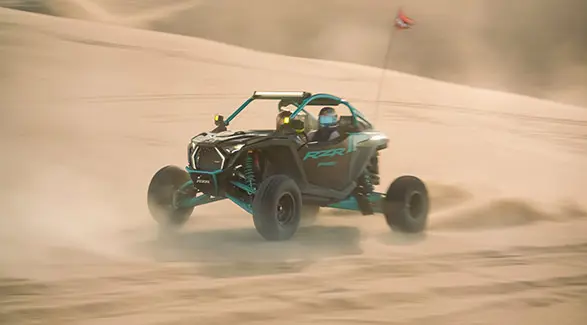 2025 Polaris RZR Pro R side-by-side speeding through the desert.