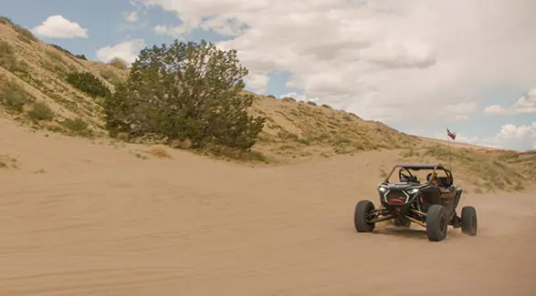 2025 Polaris RZR Pro R side-by-side driving through the desert.